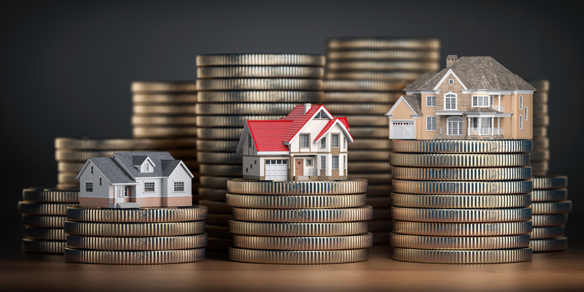 miniature house on top of stack of coins