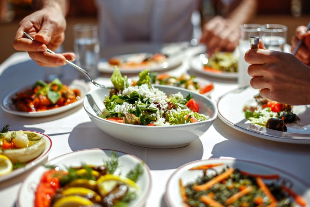 Couple  Eating Lunch with Fresh Salad and Appetizers. Restaurants in the Mississippi Gulf Coast