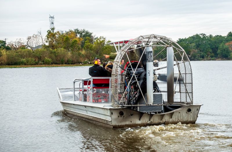 an air boat taking taking tourists on a sightseeing tour